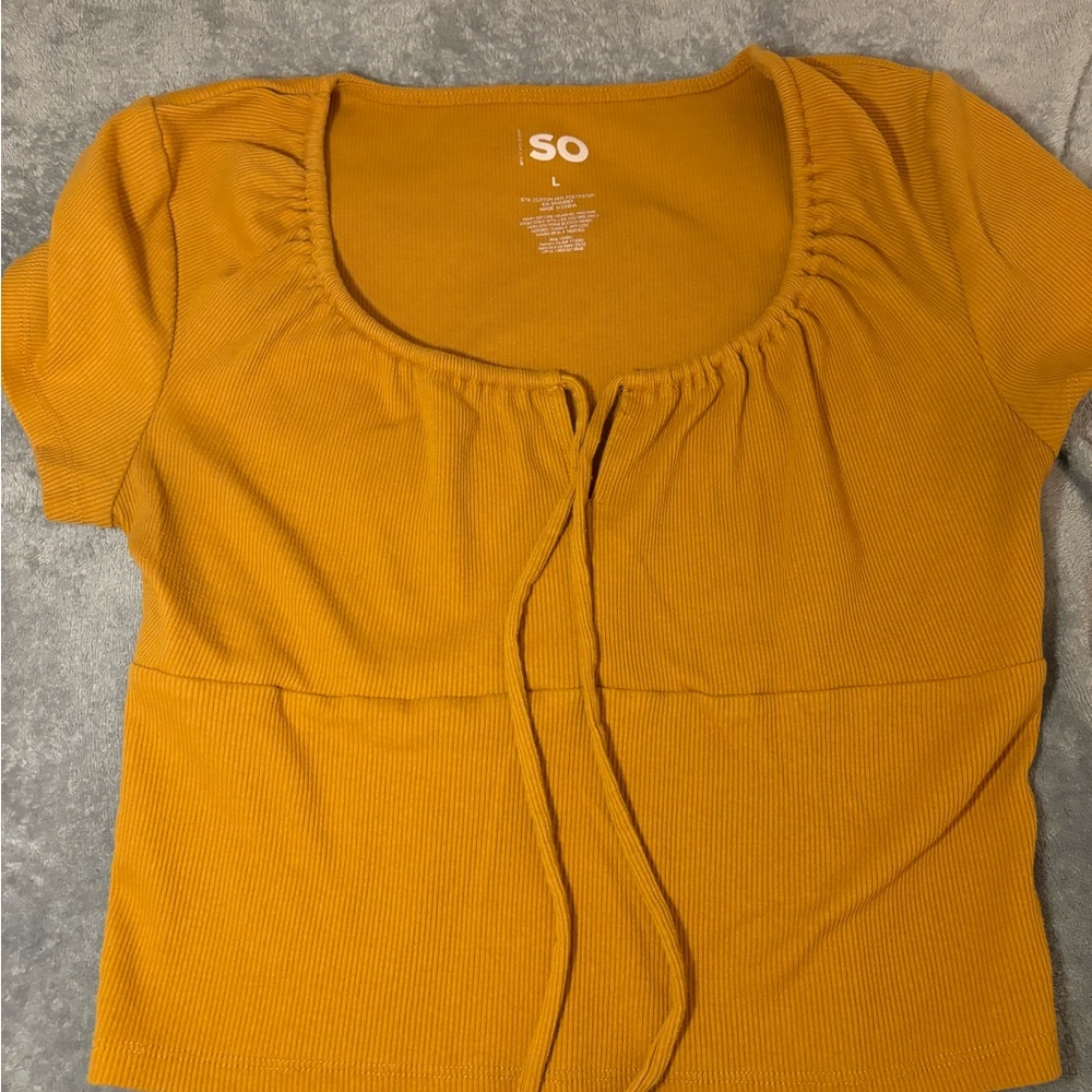 Yellow shirt with a tie in front of it